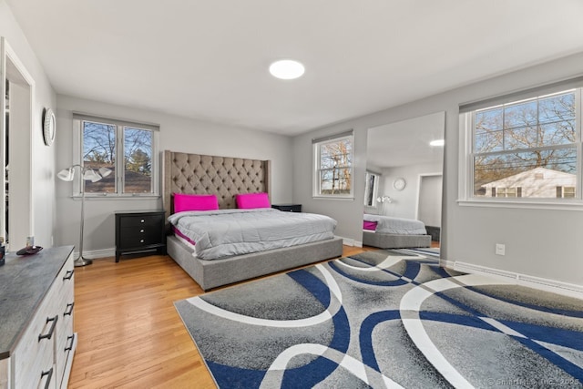 bedroom featuring baseboards and light wood-type flooring