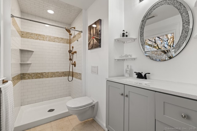 bathroom featuring tile patterned floors, vanity, toilet, and a shower stall