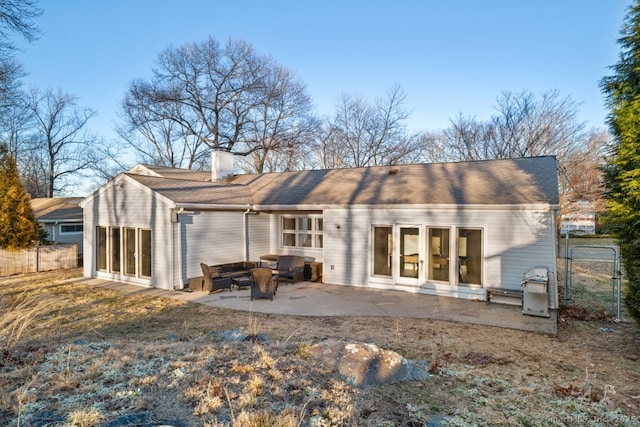 back of property with a patio area, fence, and a chimney