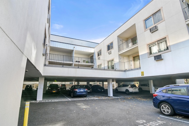 view of building exterior featuring covered parking