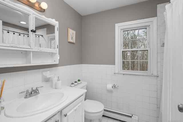 full bath featuring a wainscoted wall, toilet, tile walls, a baseboard radiator, and vanity