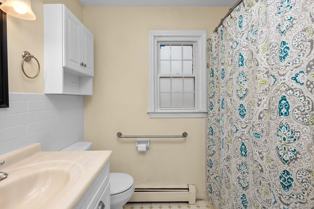 bathroom featuring a shower with curtain, toilet, tile walls, baseboard heating, and vanity