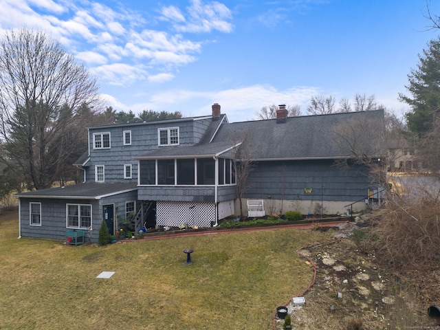 rear view of house with roof with shingles, a yard, a sunroom, a chimney, and stairs