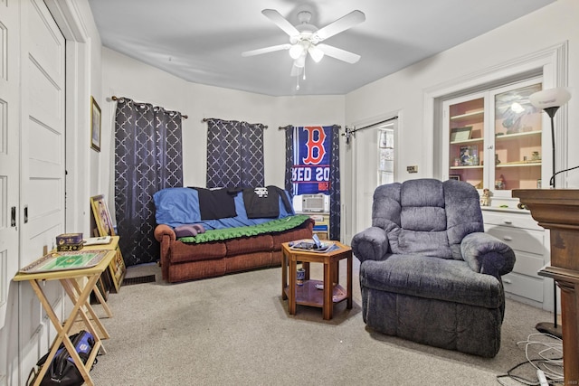 living room featuring ceiling fan and carpet