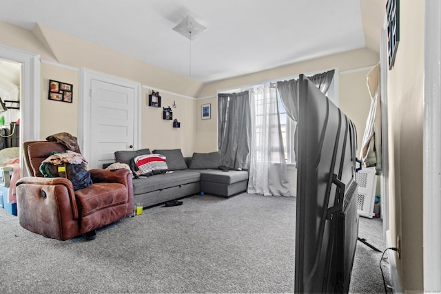 carpeted living room with lofted ceiling