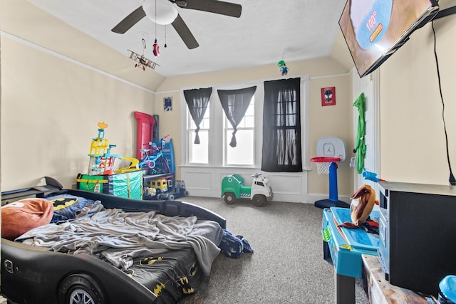 carpeted bedroom featuring ceiling fan and vaulted ceiling