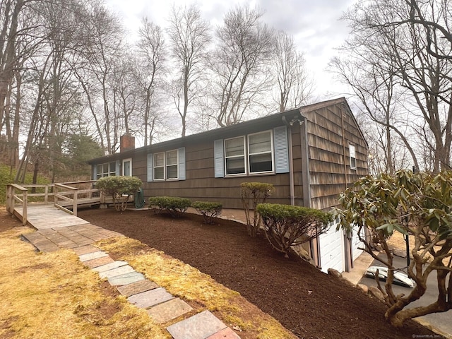 view of property exterior featuring a wooden deck and a chimney