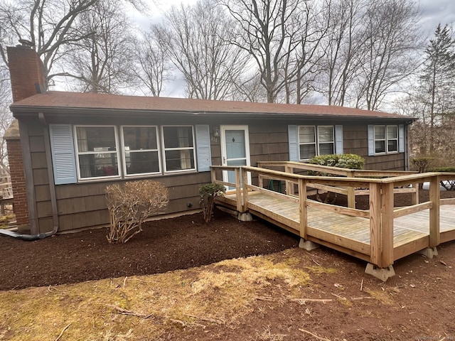 view of front of property with a wooden deck and a chimney