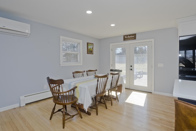 dining room featuring light wood-style flooring, french doors, a wall unit AC, and a baseboard radiator