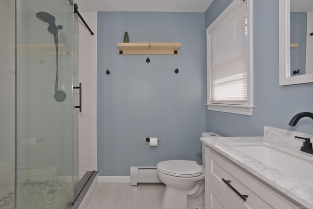 bathroom with vanity, baseboard heating, a shower stall, and toilet