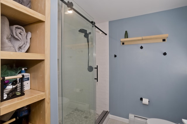 bathroom with a baseboard heating unit, baseboards, toilet, and a stall shower