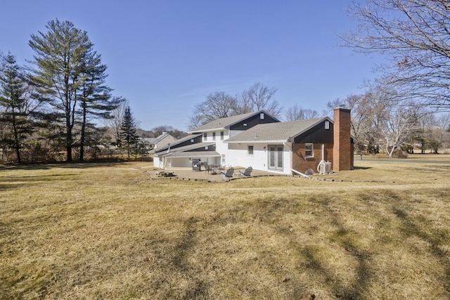 view of home's exterior with a lawn, french doors, and a chimney