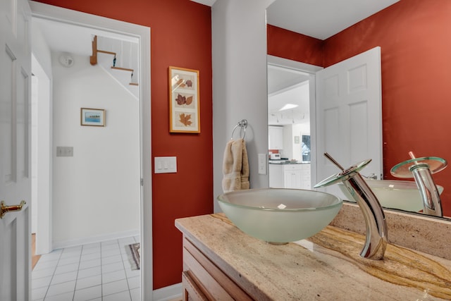 bathroom featuring vanity, tile patterned floors, and baseboards