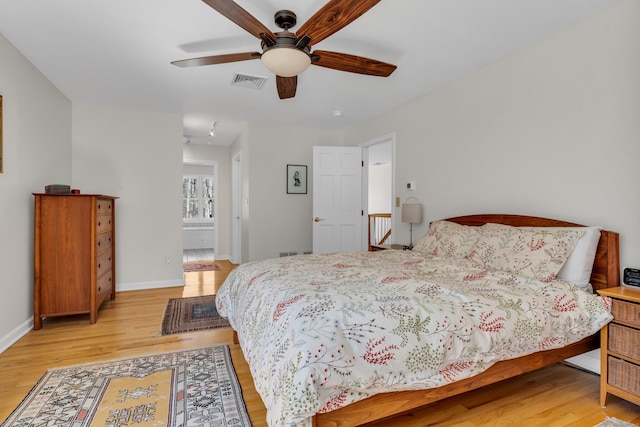 bedroom featuring visible vents, baseboards, light wood-style floors, and ceiling fan