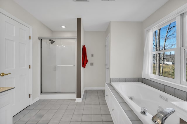 bathroom featuring a stall shower, a tub with jets, tile patterned flooring, baseboards, and vanity