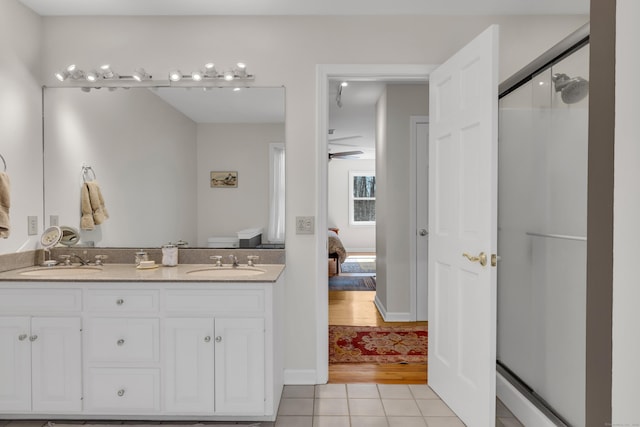 bathroom with ensuite bath, tile patterned floors, a shower stall, and a sink