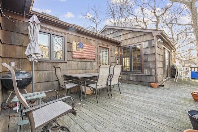 wooden terrace featuring outdoor dining area