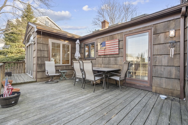 wooden terrace with outdoor dining area