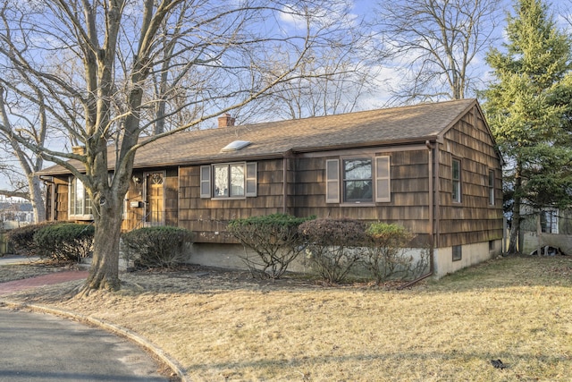 ranch-style home with crawl space, a chimney, and roof with shingles