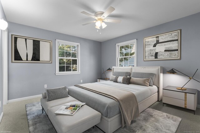 carpeted bedroom with baseboards, multiple windows, and ceiling fan