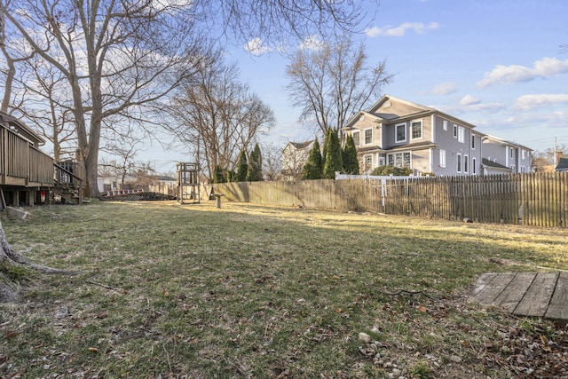 view of yard with a playground, fence, and a residential view