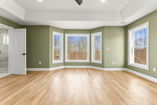 empty room featuring recessed lighting, light wood-type flooring, baseboards, and visible vents