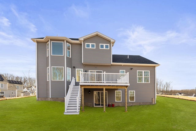 rear view of property with stairway, a lawn, and a deck