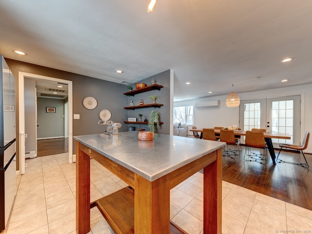 kitchen featuring stainless steel countertops, light tile patterned floors, recessed lighting, a wall mounted AC, and open shelves