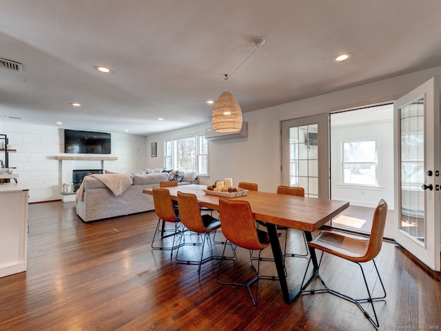 dining area with dark wood finished floors, recessed lighting, a fireplace, and visible vents