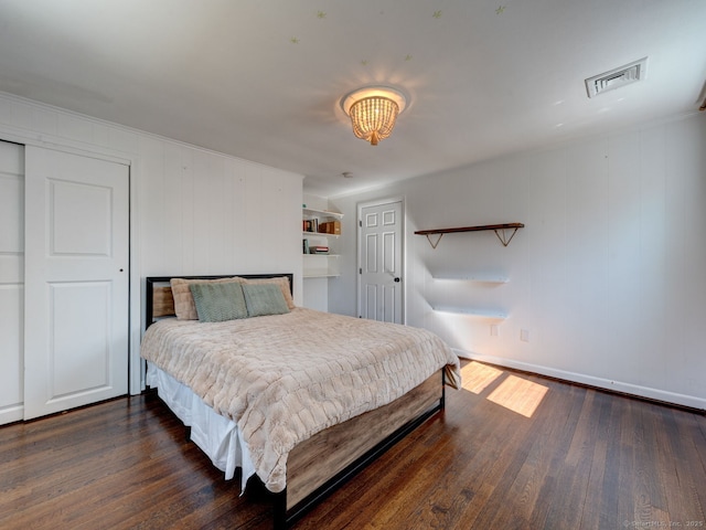 bedroom with visible vents, baseboards, and wood-type flooring