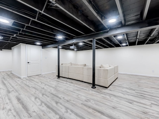 finished basement with baseboards and wood finished floors