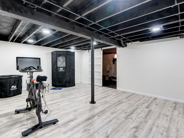 workout area with wood finished floors and baseboards