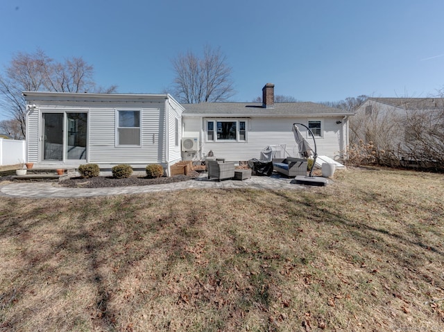 back of property featuring a patio area, a lawn, a chimney, and ac unit