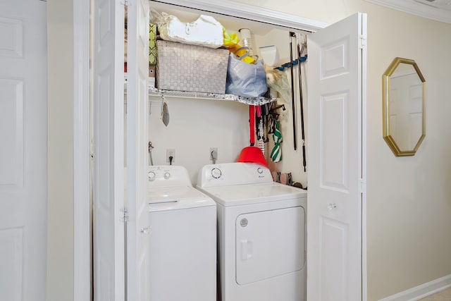 clothes washing area featuring laundry area and washer and clothes dryer