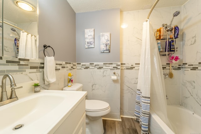 full bathroom with toilet, a textured ceiling, wood finished floors, tile walls, and shower / bath combination with curtain