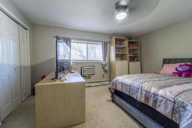 bedroom featuring a wall mounted AC, a baseboard heating unit, a closet, light colored carpet, and ceiling fan