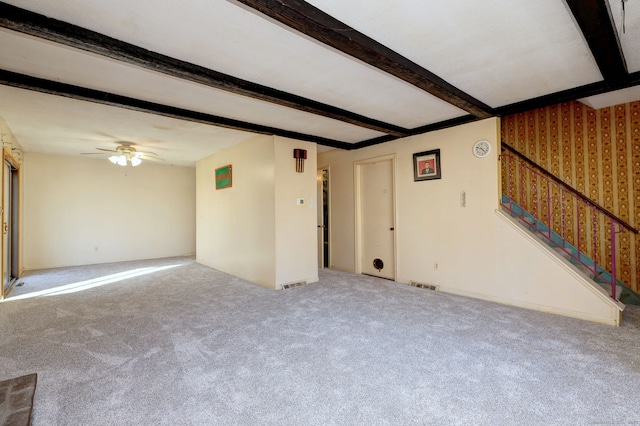 unfurnished living room with beam ceiling, visible vents, carpet, and a ceiling fan