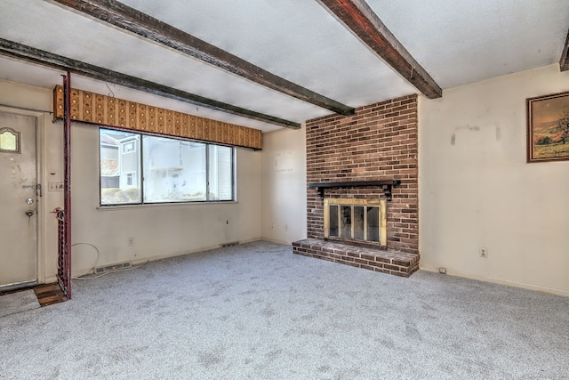 unfurnished living room featuring visible vents, beam ceiling, a fireplace, a textured ceiling, and carpet flooring