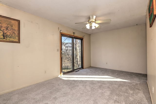 carpeted spare room featuring a ceiling fan