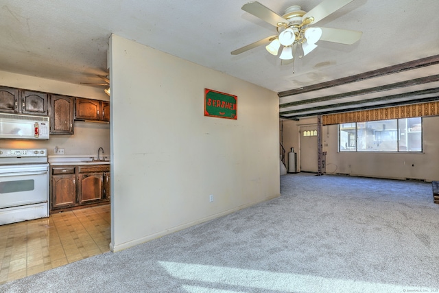 kitchen with white appliances, light countertops, a ceiling fan, and a sink