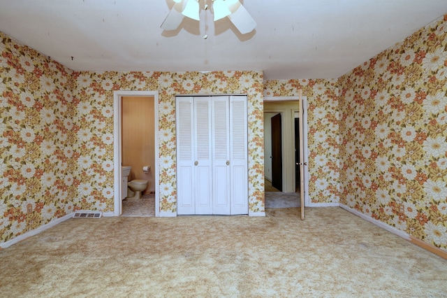 unfurnished bedroom featuring wallpapered walls, carpet flooring, and visible vents