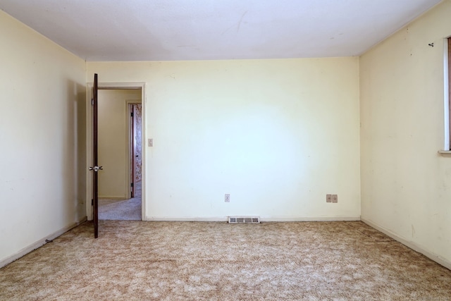 empty room featuring visible vents and carpet flooring