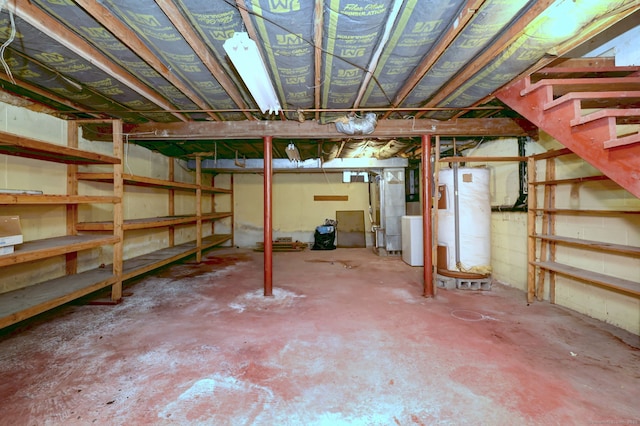 unfinished below grade area with stairway, washer / dryer, and water heater