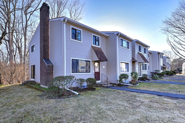 view of front of house featuring a front yard and a chimney