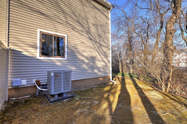 view of side of home with central air condition unit