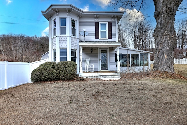 italianate house with a sunroom and fence