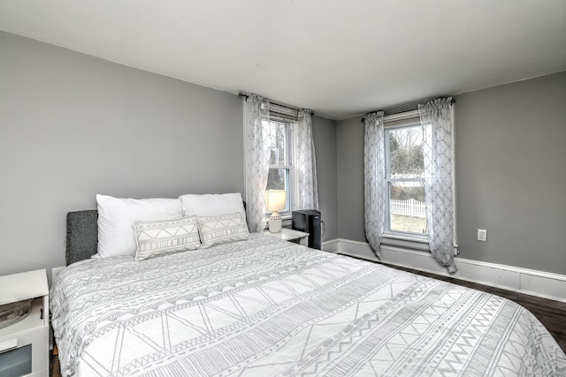 bedroom featuring wood finished floors and baseboards