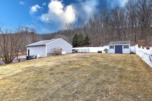 view of yard featuring an outbuilding and a fenced backyard