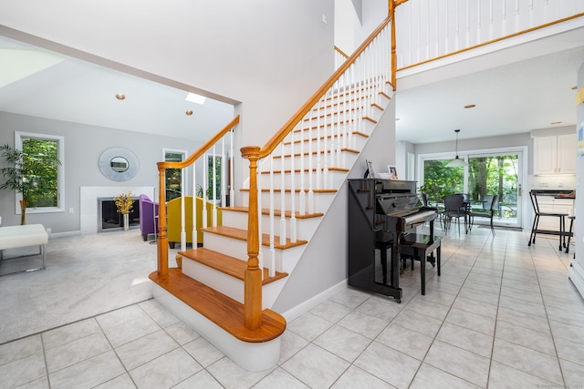 47 Jeremy River Dr, Colchester, CT 06415 - staircase featuring plenty of natural light, tile patterned floors, baseboards, and a high ceiling