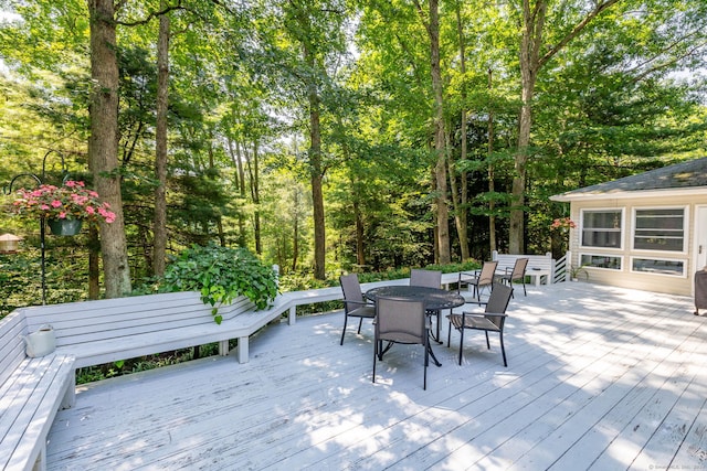 wooden deck featuring outdoor dining area